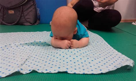 Dojenček na trebuhu s dvignjeno medenico