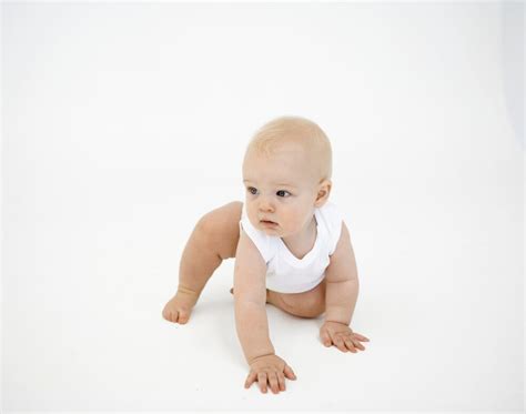 Dojenček, ki se plazi po mehki podlagi.