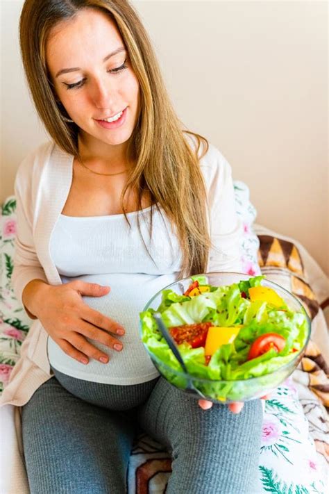 Pregnant woman considering food options