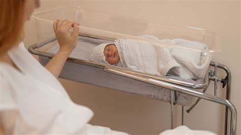 Ženska, ki jo neguje medicinska sestra v porodnišnici