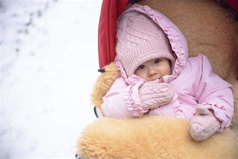 Dojenček v vozičku, pokrit z odejo