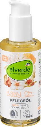 Steklenička mandljevega olja ob dojenčku