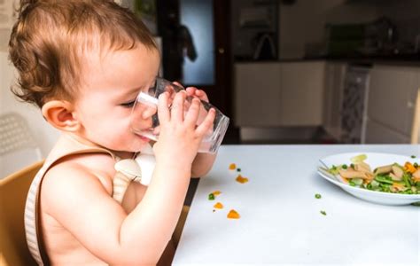 Otrok, ki pije vodo iz kozarčka