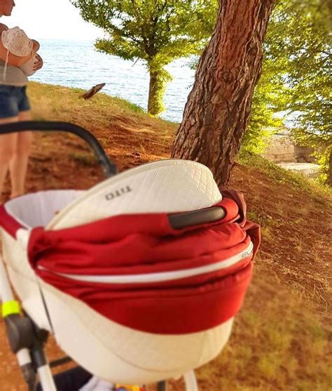 Mlada mamica teče s svojim dojenčkom v vozičku