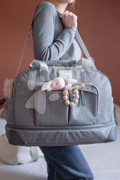 Notranjost sive jeans previjalne torbe z organiziranimi žepi