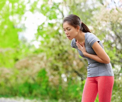 ženska z rokami na bolečih prsih